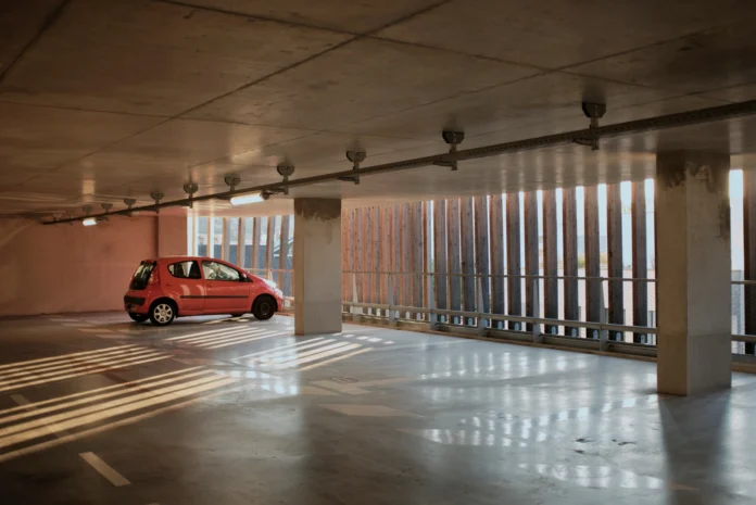 Red car parked on a smooth professional garage floor resurfacing finish